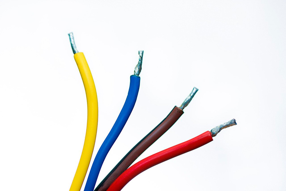 cuatro cables eléctricos de diferentes colores: amarillo, azul, negro y rojo
